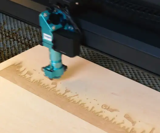laser engraving the wooden table football.webp